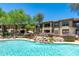 Community pool with waterfall feature surrounded by lush landscaping and patio seating at 19700 N 76Th St # 1038, Scottsdale, AZ 85255