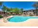 Inviting community pool with refreshing waterfall and relaxing lounge seating with lovely trees at 19700 N 76Th St # 1038, Scottsdale, AZ 85255