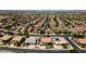 This aerial view shows a neighborhood with a street-lined of homes and desert landscaping at 20226 N Madison Dr, Maricopa, AZ 85138