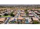 This aerial shot shows a neighborhood with neatly planned streets, green spaces, and uniform housing design at 20226 N Madison Dr, Maricopa, AZ 85138