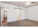 Bedroom with large windows, carpeted floors, barn door to the bathroom, and closet at 20226 N Madison Dr, Maricopa, AZ 85138