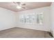 Bright bedroom with large windows with plantation shutters and carpeted floors at 20226 N Madison Dr, Maricopa, AZ 85138