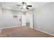 Neutral bedroom featuring plush carpet, a ceiling fan, and a large closet at 20226 N Madison Dr, Maricopa, AZ 85138
