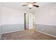 Bedroom with pink upper walls and grey lower walls, neutral carpet, and an open closet at 20226 N Madison Dr, Maricopa, AZ 85138