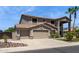 Two-story home featuring desert landscaping, a three-car garage, and a covered porch at 20226 N Madison Dr, Maricopa, AZ 85138