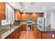 Open kitchen with cherry wood cabinets, stainless steel appliances, and granite countertops at 20226 N Madison Dr, Maricopa, AZ 85138