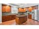 Open kitchen with cherry wood cabinets, stainless steel appliances, and granite countertops at 20226 N Madison Dr, Maricopa, AZ 85138