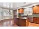 Open kitchen with cherry wood cabinets, stainless steel appliances, and granite countertops at 20226 N Madison Dr, Maricopa, AZ 85138