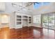 Open-concept living room featuring hardwood floors, soaring ceilings, and a sliding glass door at 20226 N Madison Dr, Maricopa, AZ 85138