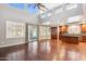 Spacious living room with tall ceilings, lots of windows, and cherry wood floors at 20226 N Madison Dr, Maricopa, AZ 85138