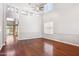 Open-concept living room featuring hardwood floors, soaring ceilings, and wainscoting at 20226 N Madison Dr, Maricopa, AZ 85138