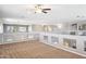 Spacious loft with neutral walls, carpet, ceiling fan, and pass-through to other areas of the house at 20226 N Madison Dr, Maricopa, AZ 85138