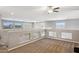 Bright loft area with neutral walls, carpet, ceiling fan, and lots of natural light from large windows at 20226 N Madison Dr, Maricopa, AZ 85138