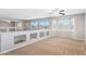 Neutral loft with neutral carpet, ceiling fan, and lots of natural light from bay windows at 20226 N Madison Dr, Maricopa, AZ 85138