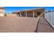 Rear view of the home showing the covered patio and gravel landscaping at 20911 E Excelsior Ave, Queen Creek, AZ 85142