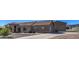Charming single-story home with a stone and stucco exterior, tile roof, desert landscaping, and a long driveway at 20911 E Excelsior Ave, Queen Creek, AZ 85142