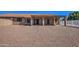 Exterior rear of home with covered patio and a spacious gravel yard at 20911 E Excelsior Ave, Queen Creek, AZ 85142