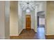 Welcoming foyer with wood floors, a stylish pendant light, and an arched doorway leading to the living area at 20911 E Excelsior Ave, Queen Creek, AZ 85142