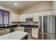 Well-lit kitchen featuring stainless steel appliances, an island, and neutral-toned cabinets at 20911 E Excelsior Ave, Queen Creek, AZ 85142