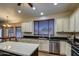 Modern kitchen with stainless steel appliances, granite counters, and center island at 20911 E Excelsior Ave, Queen Creek, AZ 85142