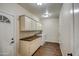 Functional laundry room with ample storage and a folding counter at 20911 E Excelsior Ave, Queen Creek, AZ 85142