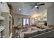 Open living room featuring a ceiling fan, fireplace, and access to dining and kitchen spaces at 20911 E Excelsior Ave, Queen Creek, AZ 85142