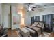 This beautiful bedroom features tall ceilings, modern decor and an attached bathroom at 20911 E Excelsior Ave, Queen Creek, AZ 85142