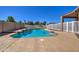 Backyard pool featuring a baja step, white picket fence, and concrete surround at 20911 E Excelsior Ave, Queen Creek, AZ 85142