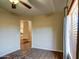 Versatile room with hardwood floors, arched entryway, a large window, and neutral decor, perfect for customization at 20911 E Excelsior Ave, Queen Creek, AZ 85142