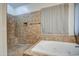 Tiled shower and soaking tub with a tiled surround at 20911 E Excelsior Ave, Queen Creek, AZ 85142