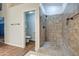 Tiled shower with seating and an adjacent separate water closet with toilet at 20911 E Excelsior Ave, Queen Creek, AZ 85142