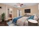 Serene bedroom with wood floors, ceiling fan, and a glimpse of an en-suite bathroom at 21136 N 36Th Pl, Phoenix, AZ 85050
