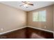 Bedroom with ceiling fan and hardwood floors, complemented by a window offering natural light at 21136 N 36Th Pl, Phoenix, AZ 85050