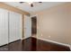 Bedroom with hardwood floors features a sliding door closet and an access door at 21136 N 36Th Pl, Phoenix, AZ 85050