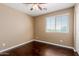 This bedroom boasts hardwood floors, a ceiling fan, and a bright window at 21136 N 36Th Pl, Phoenix, AZ 85050