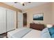 Relaxing bedroom with a ceiling fan, minimalist decor, and ample closet space at 21136 N 36Th Pl, Phoenix, AZ 85050