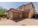 Exterior of home with a two-car garage, concrete tile roof, and desert landscaping at 21136 N 36Th Pl, Phoenix, AZ 85050