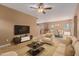 Inviting living room with neutral decor, a ceiling fan, and an open layout leading to the dining area at 21136 N 36Th Pl, Phoenix, AZ 85050