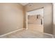 An unfurnished living room with tile flooring, and an open view to the stairwell and kitchen at 21136 N 36Th Pl, Phoenix, AZ 85050
