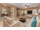 Cozy living room with neutral furnishings, a ceiling fan, and a stylish area rug at 21136 N 36Th Pl, Phoenix, AZ 85050