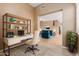Stylish home office with a modern desk setup and an open view of the living area at 21136 N 36Th Pl, Phoenix, AZ 85050