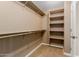 Walk-in closet features shelving and an access door at 21136 N 36Th Pl, Phoenix, AZ 85050