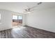 Bright bedroom with wood-look flooring, neutral paint, and sliding glass doors at 22012 E Wayward Ln, Red Rock, AZ 85145