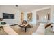 Spacious living room with modern decor, stylish furniture, and ample natural light at 23098 E Nightingale Rd, Queen Creek, AZ 85142
