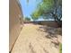 Spacious backyard of a tan home with a gravel ground cover at 23771 W Yavapai St, Buckeye, AZ 85326