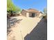 Backyard with gravel and tan home at 23771 W Yavapai St, Buckeye, AZ 85326
