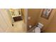 Well-lit bathroom featuring a toilet and dark vanity with dual sinks and tile floors at 23771 W Yavapai St, Buckeye, AZ 85326