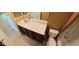 Bathroom with a long vanity, dark wood cabinets, and neutral tiled floors at 23771 W Yavapai St, Buckeye, AZ 85326