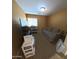 Well-lit bedroom with a comfortable sofa, perfect for relaxation or as a guest room at 23771 W Yavapai St, Buckeye, AZ 85326