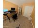 Bedroom with a desk, a comfortable chair, and a closet, ideal for a home office at 23771 W Yavapai St, Buckeye, AZ 85326